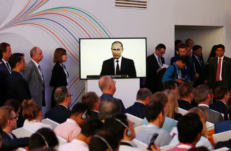 Russian President Vladimir Putin is seen on a television screen as he speaks during a joint news statement after India-Russia Annual Summit in Benaulim, in the western state of Goa, India, October 15, 2016. REUTERS/Danish Siddiqui