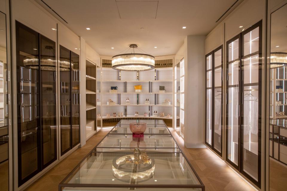 a chandelier lights a walk-in closet in mansion The One Bel Air