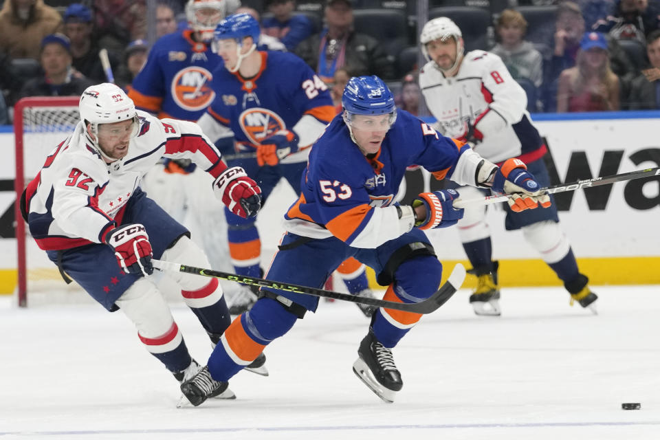 Washington Capitals center Evgeny Kuznetsov (92) defends against New York Islanders center Casey Cizikas (53) during the second period of an NHL hockey game Saturday, March 11, 2023, in Elmont, N.Y. (AP Photo/Mary Altaffer)