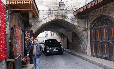 A man walks past a shop in al-Jdeideh neighbourhood, in the Old City of Aleppo, Syria December 12, 2009. REUTERS/Khalil Ashawi/Files