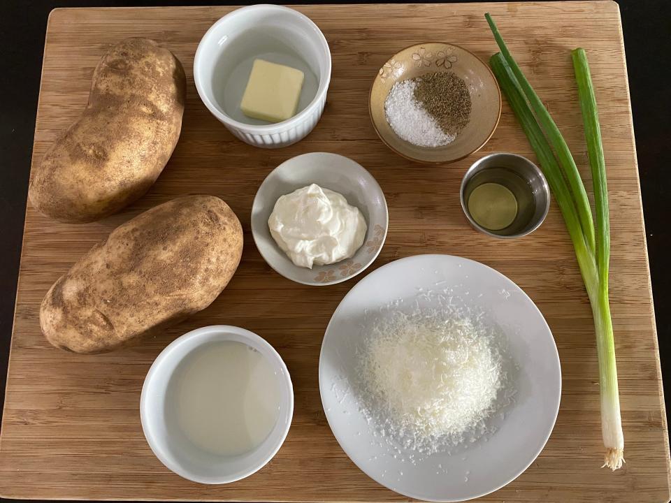 ingredients for nancy fuller's twice baked potatoes on a cutting board in a kitchen