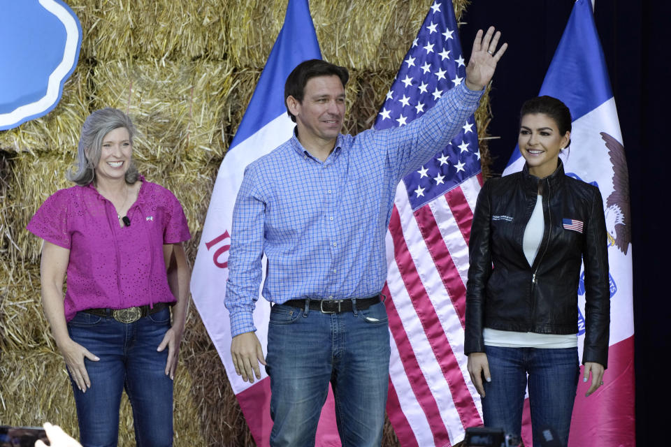 FILE - Republican presidential candidate and Florida Gov. Ron DeSantis stands on stage with his wife, Casey, right, and U.S. Sen. Joni Ernst, R-Iowa, during Ernst's Roast and Ride, Saturday, June 3, 2023, in Des Moines, Iowa. (AP Photo/Charlie Neibergall, File)