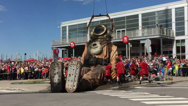 Marionettes as tall as houses march along Montreal streets during 375th birthday bash