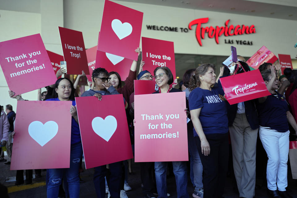 Tropicana employees hold up signs during a ceremony marking the closing of the historic property at the Tropicana hotel-casino Tuesday, April 2, 2024, in Las Vegas. The hotel-casino is slated for demolition in October to make room for a $1.5 billion baseball stadium. (AP Photo/John Locher)