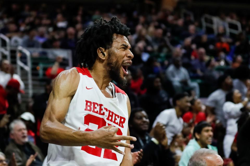 Flint Beecher forward Robert Lee Jr. celebrates a play made by teammates from the sideline during the second half of Beecher's 64-50 win in the Division 3 final at Breslin Center on Saturday, March 25, 2023.
