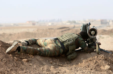 A Kurdish Peshmerga fighter looks through a Milan missile before recapturing from Islamic state militants the Fadiliya village in Nawaran, north of Mosul, Iraq, October 27, 2016. REUTERS/Air Jalal