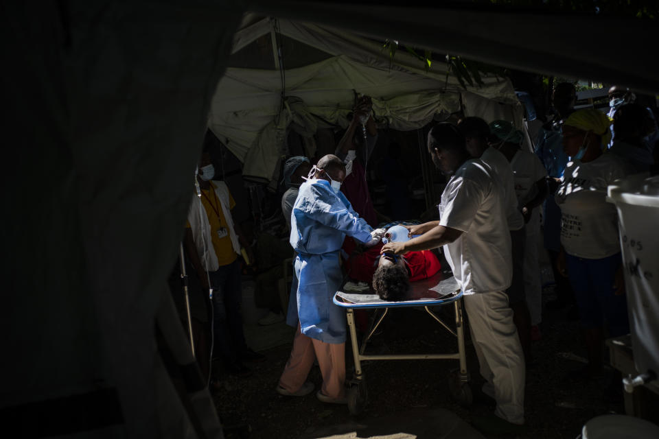 Doctors try to save Stanley Joliva, a patient with cholera symptoms, at a clinic run by Doctors Without Borders in Port-au-Prince, Haiti, Thursday, Oct. 27, 2022. For the first time in three years, people in Haiti have been dying of cholera, raising concerns about a potentially fast-spreading scenario and reviving memories of an epidemic that killed nearly 10,000 people a decade ago. (AP Photo/Ramon Espinosa)