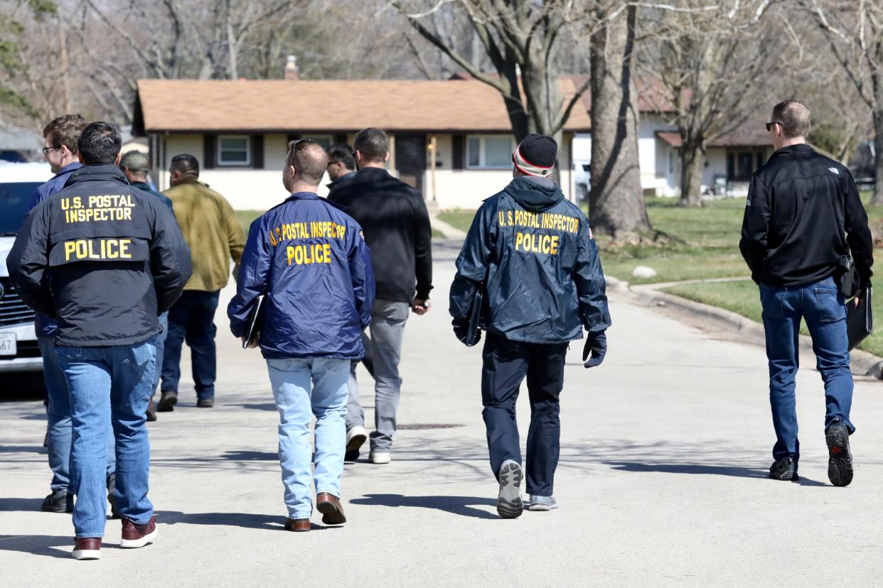 A group of U.S. Postal Inspector police walk down Winnetka Drive Thursday, March 28, 2024, in Rockford. A U.S. Postal carrier was one of four fatalities on Wednesday, March 27, 2024, after a man with a knife went on a killing spree through his neighborhood.