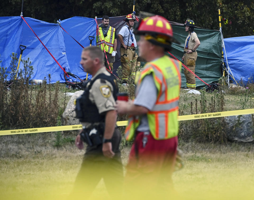 Firefighters and the Carver County Sheriffs Department work the scene of a plane crash , Sunday, Aug. 8, 2021 in Victoria, Minn. Three people died when a single-engine plane crashed into a vacant lot and burst into flames in a small southeastern Minnesota city, a National Transportation Safety Board official said Sunday.(Aaron Lavinsky/Star Tribune via AP)