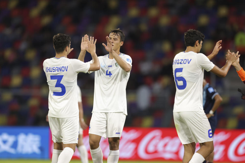 Players of Uzbekistan celebrates after defeating 2-0 Guatemala during a FIFA U-20 World Cup Group A soccer match at the Madre De Ciudades stadium in Santiago del Estero, Argentina, Friday, May 26, 2023. (AP Photo/Nicolas Aguilera)