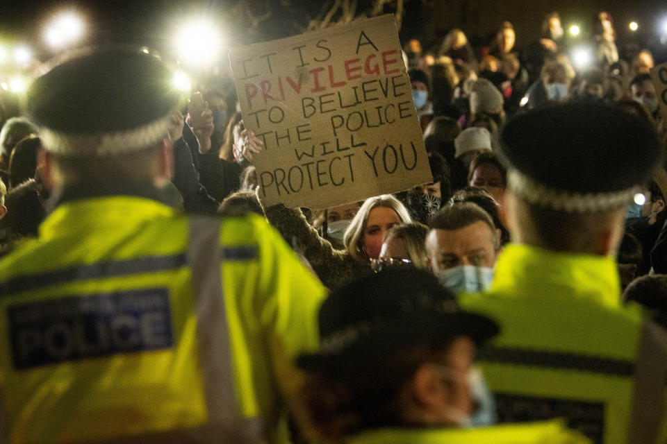 A woman holds up a placard as people gather in Clapham Common, London, after the Reclaim These Streets vigil for Sarah Everard was officially cancelled. Serving police constable Wayne Couzens, 48, has appeared in court charged with kidnapping and killing the marketing executive, who went missing while walking home from a friend's flat in south London on March 3. Picture date: Saturday March 13, 2021.