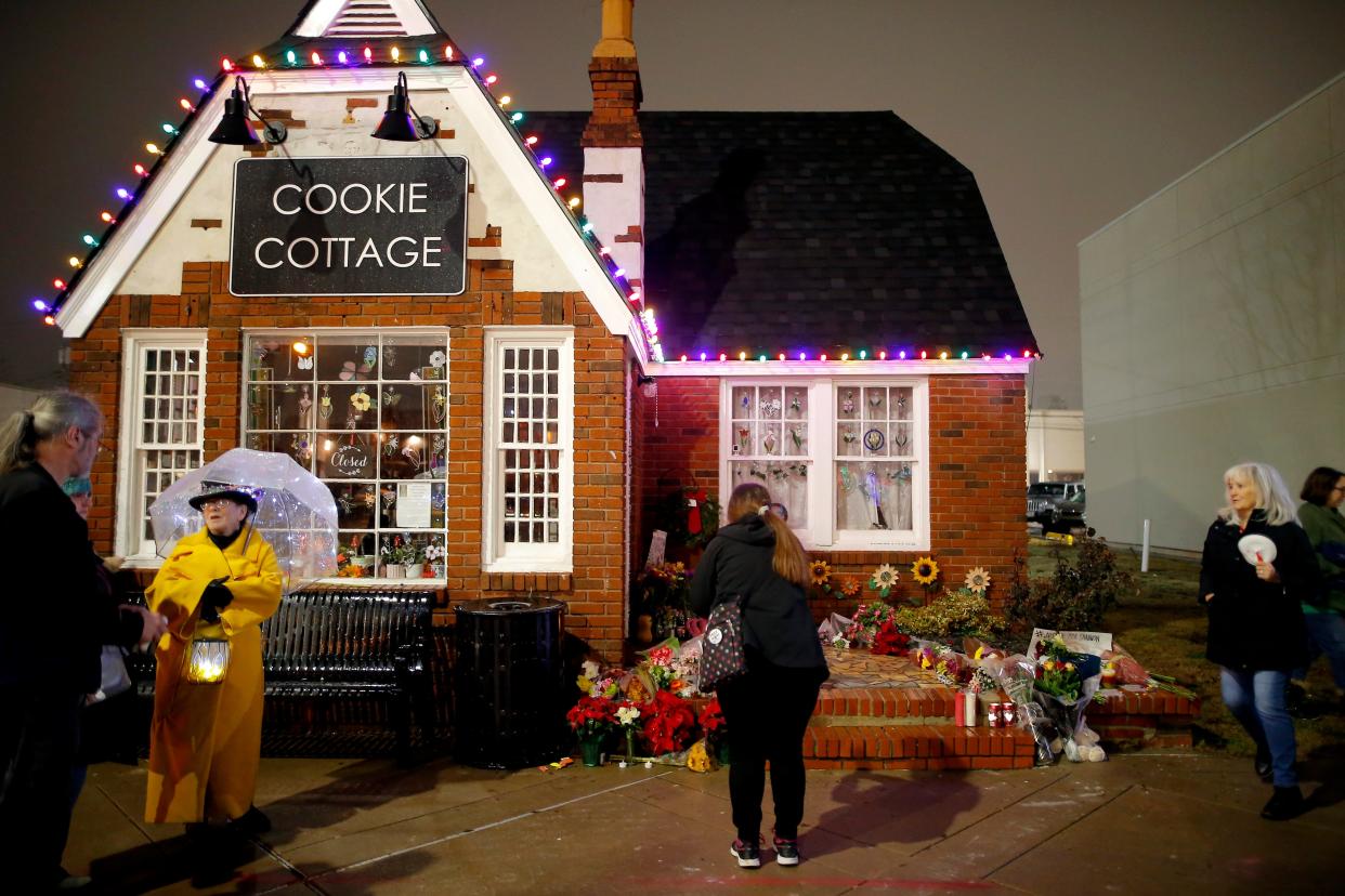 People gather outside the Cookie Cottage before a candlelight vigil for Shannon Hanchett on Monday in Norman. Hanchett, a local bakery owner and longtime mental health advocate, died at the Cleveland County jail early Thursday.