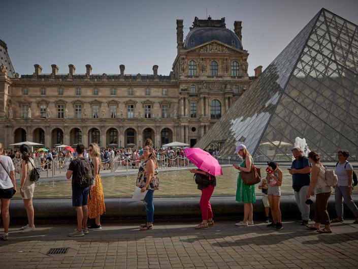 tourists at the louvre museum