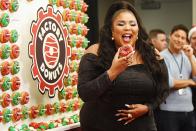 Lizzo looks ultra glam as she snacks on a doughnut at Q102’s Jingle Ball presented by Capital One at Wells Fargo Center on Wednesday in Philadelphia.