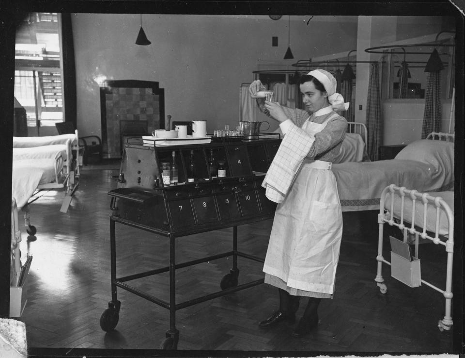 A nurse measuring medicine from an open medicine trolley, in a ward at St Bartholomew’s Hospital, West Smithfield, Greater London Authority