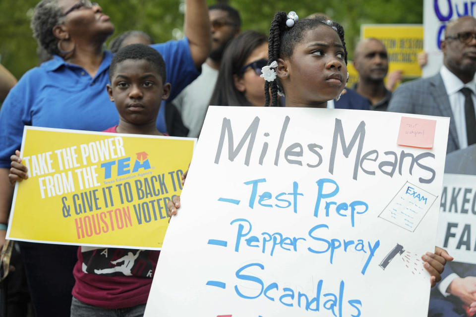 Children carry signs to protest against the state takeover of the Houston Independent School District (Yi-Chin Lee / AP file)