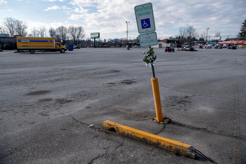 A small wreath is seen on a parking marker in the parking lot of Henderson Crossing Plaza March 4, 2024, in honor of Elijah Timmons III, who was shot and killed nearby.