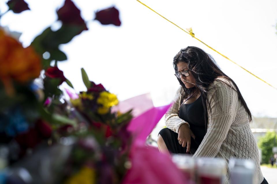 Yanilka Faneyte pays her respects at a memorial