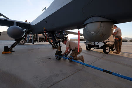 A U.S. airman secures an MQ-9 Reaper drone after it returned from a mission at Kandahar Air Field in Afghanistan March 9, 2016. REUTERS/Josh Smith