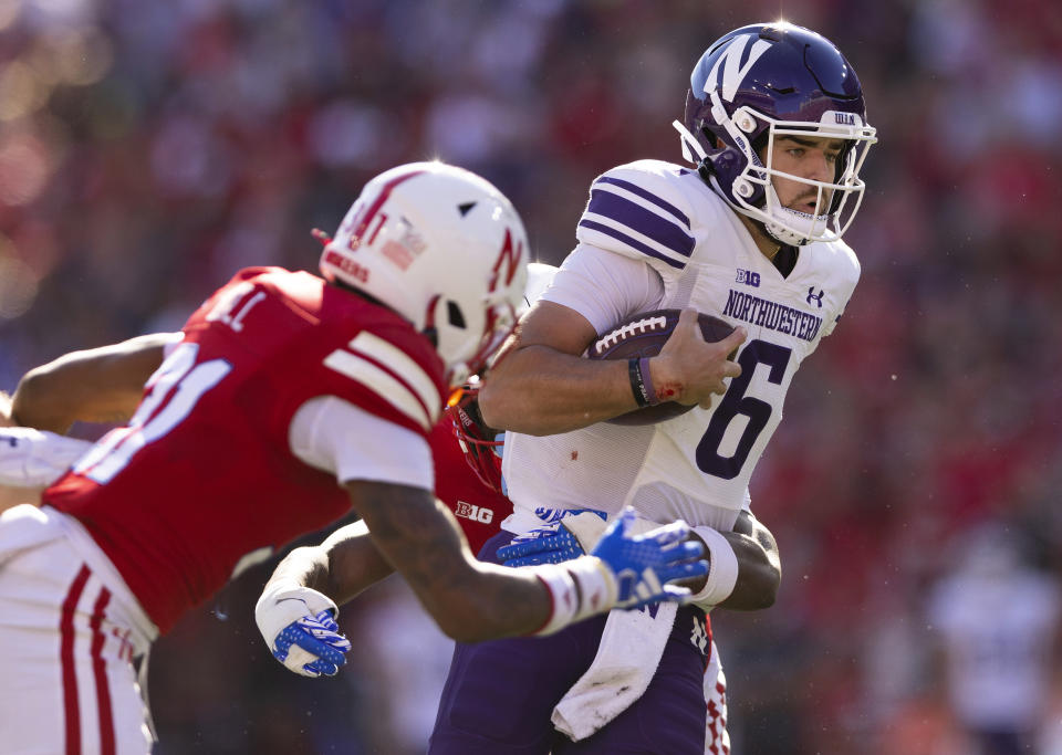 Northwestern quarterback Brendan Sullivan (6) carries the ball against Nebraska's Tommi Hill (31) during the first half of an NCAA college football game Saturday, Oct. 21, 2023, in Lincoln, Neb. (AP Photo/Rebecca S. Gratz)