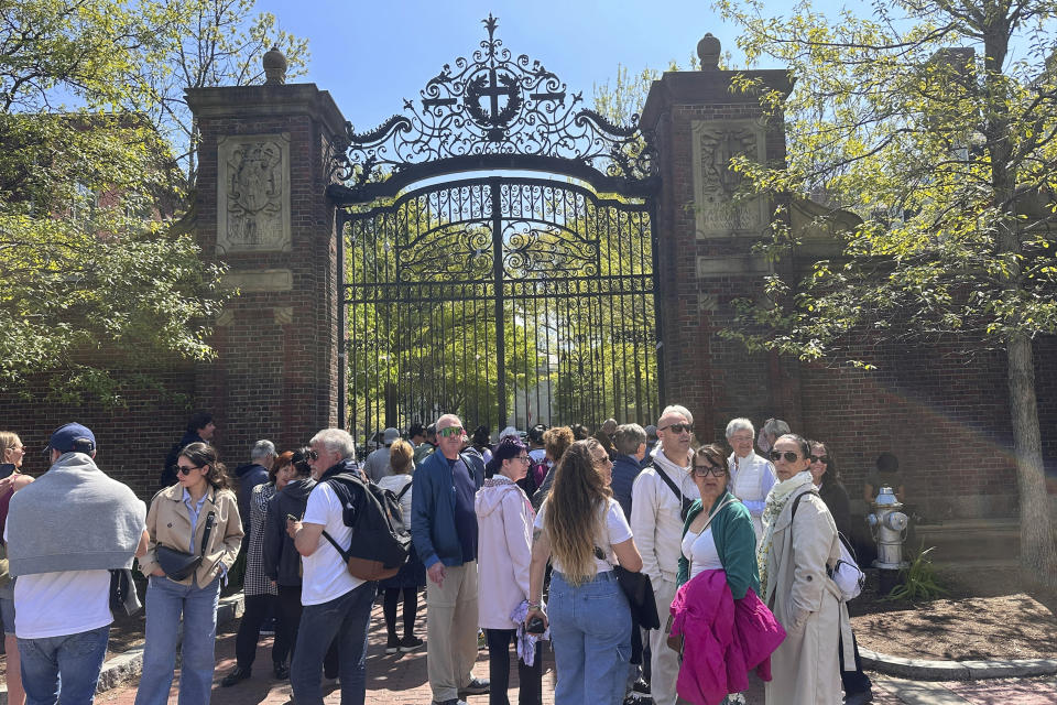 Tourists flocked to Harvard Yard on Harvard University to catch a glimpse of an encampment set up to protest the war in Gaza, Tuesday, May 14, 2024, in Cambridge, Mass. The encampment was being voluntarily removed early Tuesday. (AP Photo/Michael Casey)