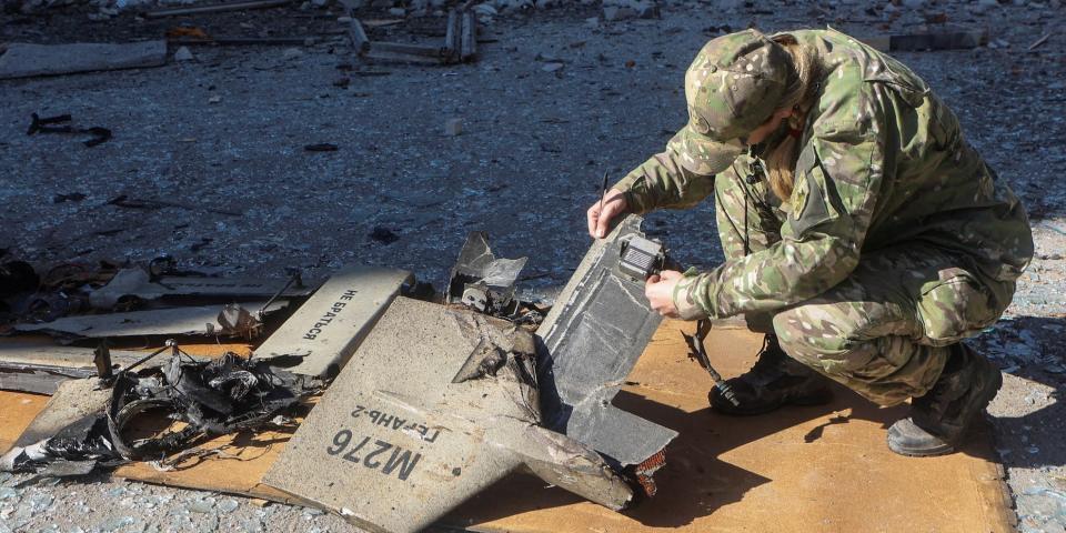 A police officer inspects parts of an unmanned aerial vehicle (UAV), what Ukrainian authorities consider to be an Iranian made suicide drone Shahed-136, at a site of a Russian strike on fuel storage facilities, amid Russia's attack on Ukraine, in Kharkiv, Ukraine October 6, 2022.