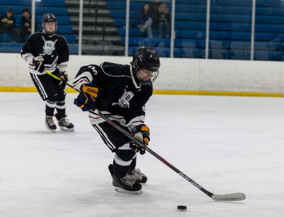 Kenny Stucki of Airport prepares to pass the puck during New Boston United's 8-0 loss to Plymouth in the Division 1 Regional in Livonia Wednesday.