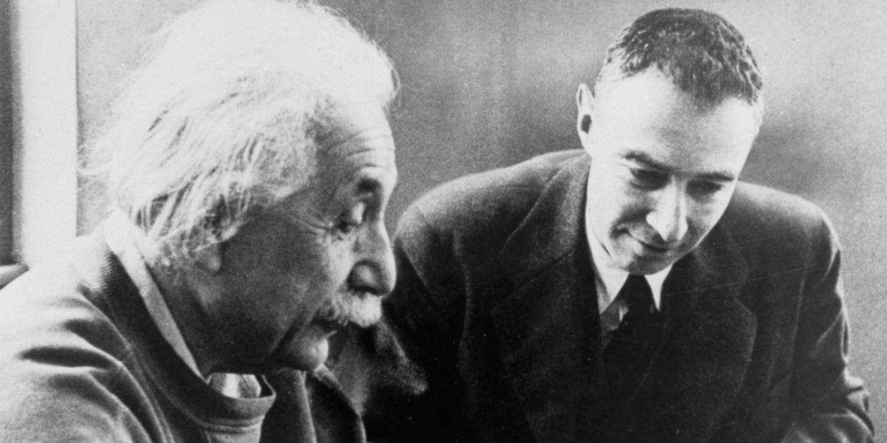 J. Robert Oppenheimer working with Albert Einstein.