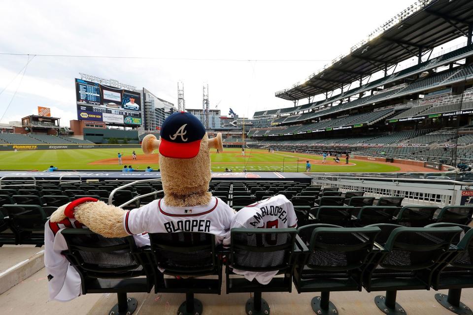 <p>Blooper, mascot of the Atlanta Braves, sits in the empty stands to watch the exhibition game between the Atlanta Braves and the Miami Marlins at Truist Park on July 22 in Atlanta.</p>