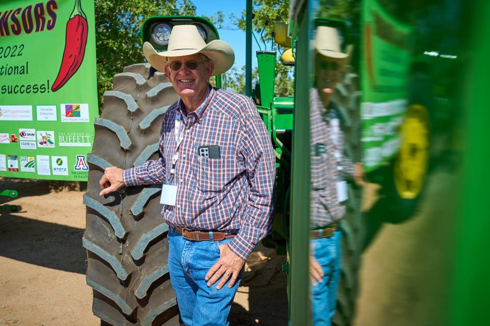 Ed Curry of Curry Farms poses for a portrait next to one of the tractors during the 25th International Pepper Conference at Curry Farms in Pearce, Arizona on Tuesday, Sept. 27, 2022.