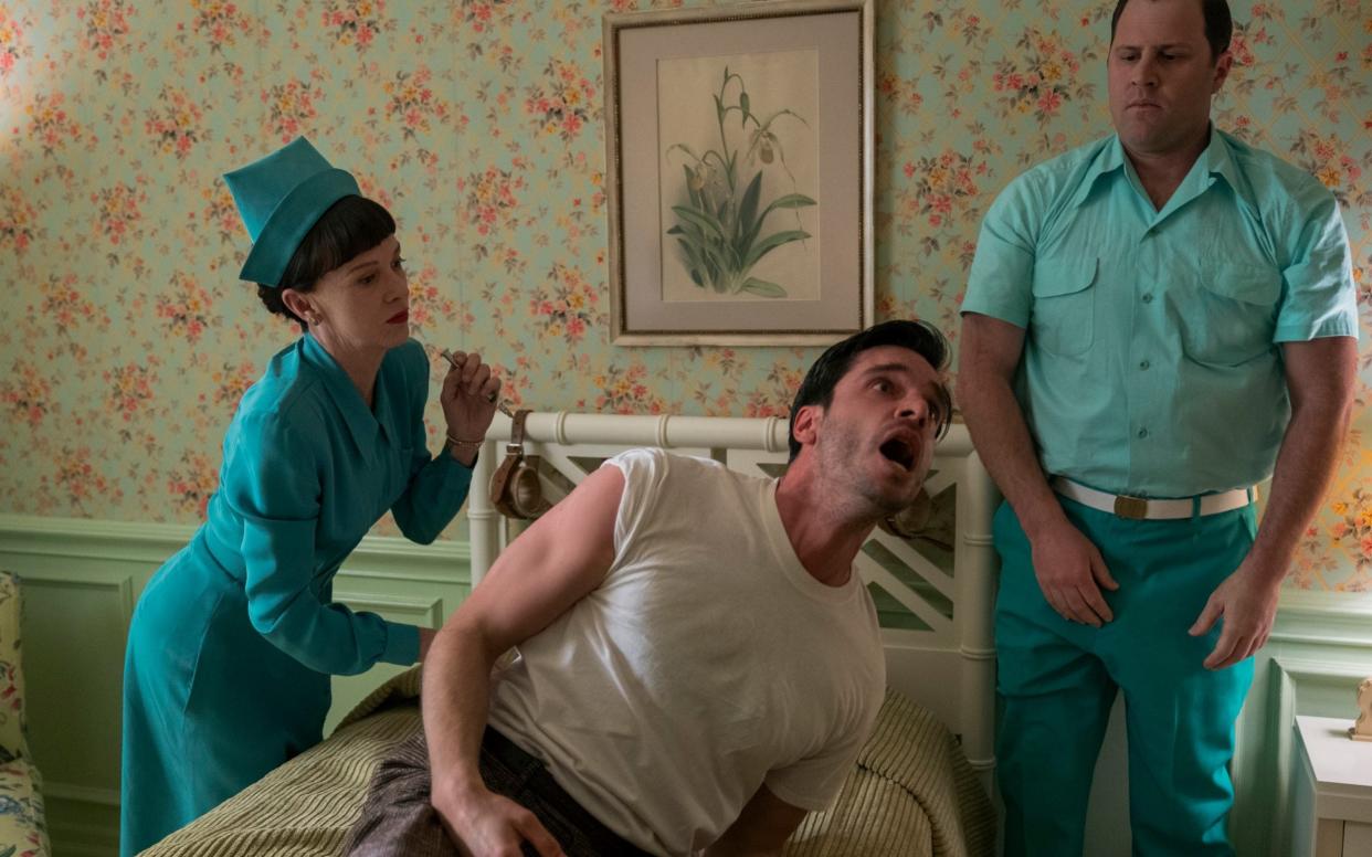 The most blood-curdling experiments in Ratched are inspired by real life: Judy Davis (l) as Nurse Bucket and Daniel Tomasso as Dario - Saeed Adyani