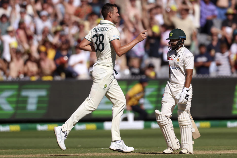 Australia's Josh Hazlewood, left, celebrates after bowling Pakistan's Saud Shakeel, right, during the second day of their cricket test match in Melbourne, Wednesday, Dec. 27, 2023. (AP Photo/Asanka Brendon Ratnayake)