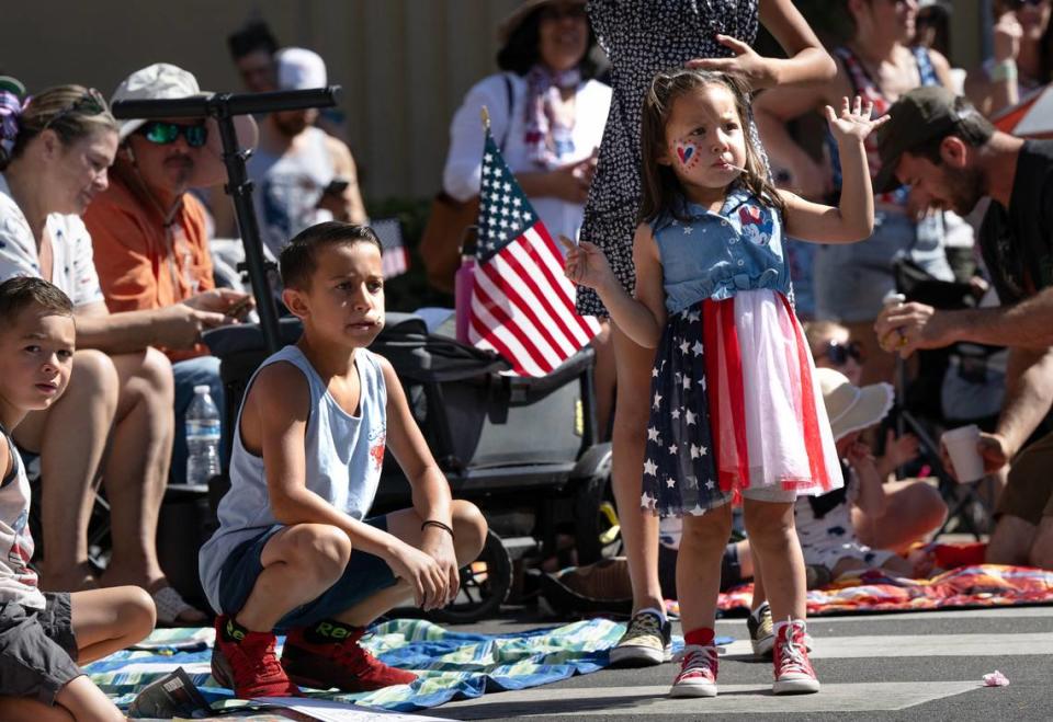 Ava Nayares, 4, and her brother Landon Middleton, 7, left, watch the Independence Day Parade on J Street as hundreds lined the downtown streets in Modesto, Calif., Tuesday, July 4, 2023. Andy Alfaro/aalfaro@modbee.com