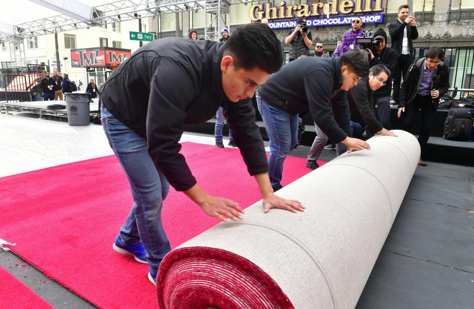 People rolling out the red carpet