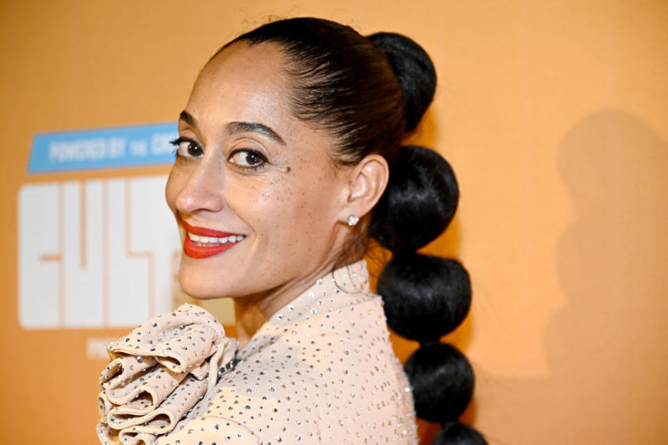 closeup of tracee smiling at an event with a long ponytail