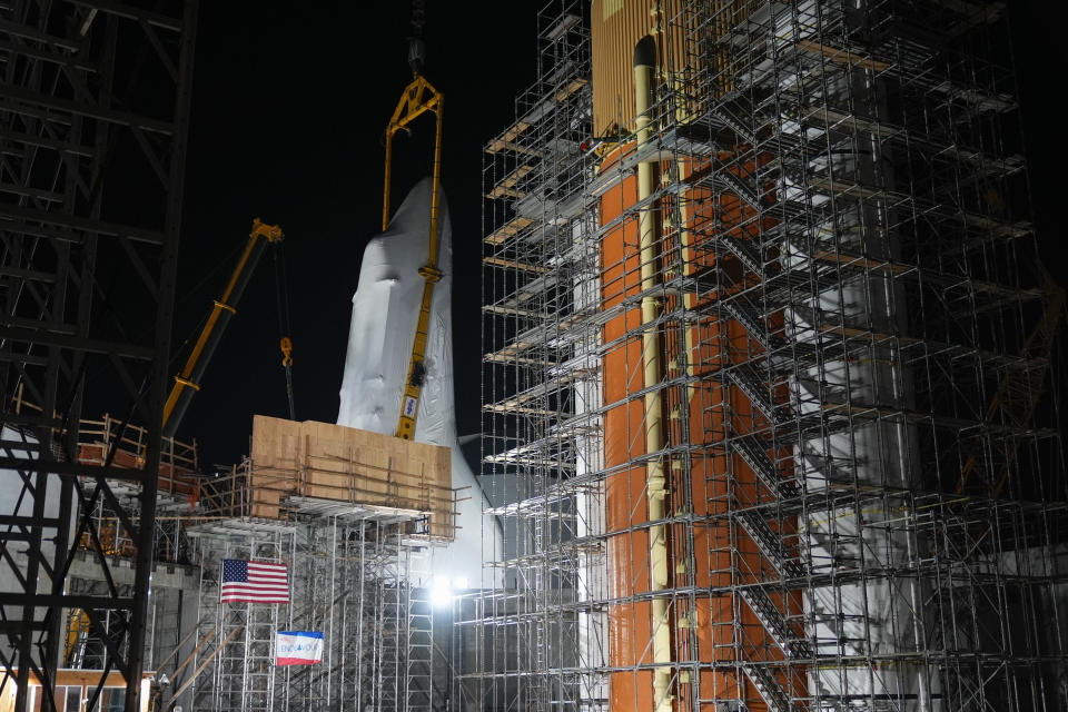 Space Shuttle Endeavour is lifted into the site of the future Samuel Oschin Air and Space Center on Monday, Jan. 29, 2024, in Los Angeles. (AP Photo/Ashley Landis)