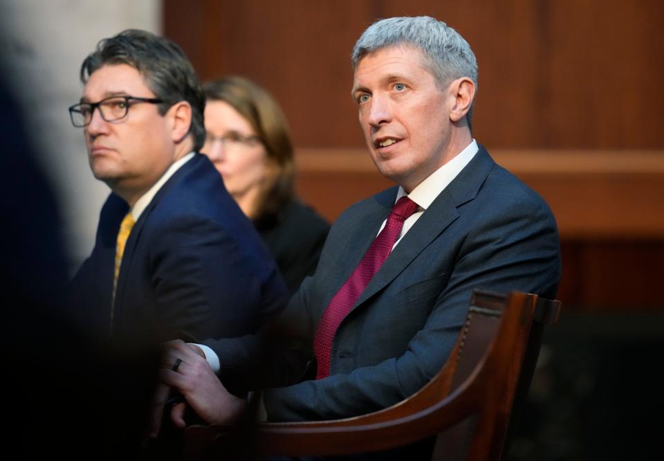 Attorneys Eric Olson, right, and Sean Grimsley listen as Jason Murray argues before the Colorado Supreme Court on Wednesday, Dec. 6, 2023, in Denver. The oral arguments before the court were held after both sides appealed a ruling by a Denver district judge on whether to allow former President Donald Trump to be included on the state's general election ballot. (AP Photo/David Zalubowski, Pool)
