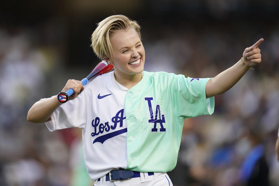 Jojo Siwa gestures on the field during the MLB All Star Celebrity Softball game, Saturday, July 16, 2022, in Los Angeles. (AP Photo/Abbie Parr)