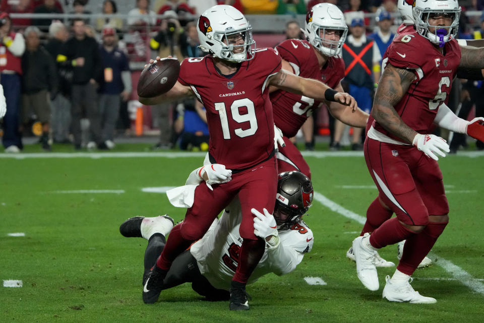 Arizona Cardinals quarterback Trace McSorley (19) is hit by Tampa Bay Buccaneers linebacker Joe Tryon-Shoyinka (9) during the first half of an NFL football game, Sunday, Dec. 25, 2022, in Glendale, Ariz. (AP Photo/Rick Scuteri)