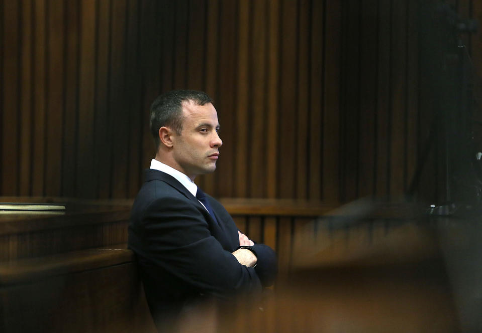 Oscar Pistorius listens to evidence being given in court in Pretoria, South Africa, Tuesday, April 15, 2014 after questioning by state prosecutor Gerrie Nel, had earlier finished. Pistorius is charged with the murder of his girlfriend Reeva Steenkamp, on Valentines Day in 2013. (AP Photo/Alon Skuy, Pool)