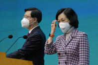 Hong Kong Chief Executive John Lee, left, and convener of the Executive Council Regina Ip attend a news conference in Hong Kong, Tuesday, July 5, 2022. Lee said Tuesday in his first news conference since taking the reins that he will work towards legislating easing restrictions for travelers, but that it must be balanced with limiting the spread of the coronavirus so as not to overwhelm the healthcare system. (AP Photo/Kin Cheung)