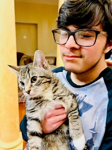 Raiiyaan-Ali Malik with the family cat, Anakin, at their home in Dublin.