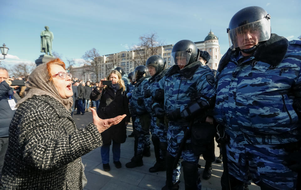 A woman argues with law enforcement officers as they block a rally in Moscow.