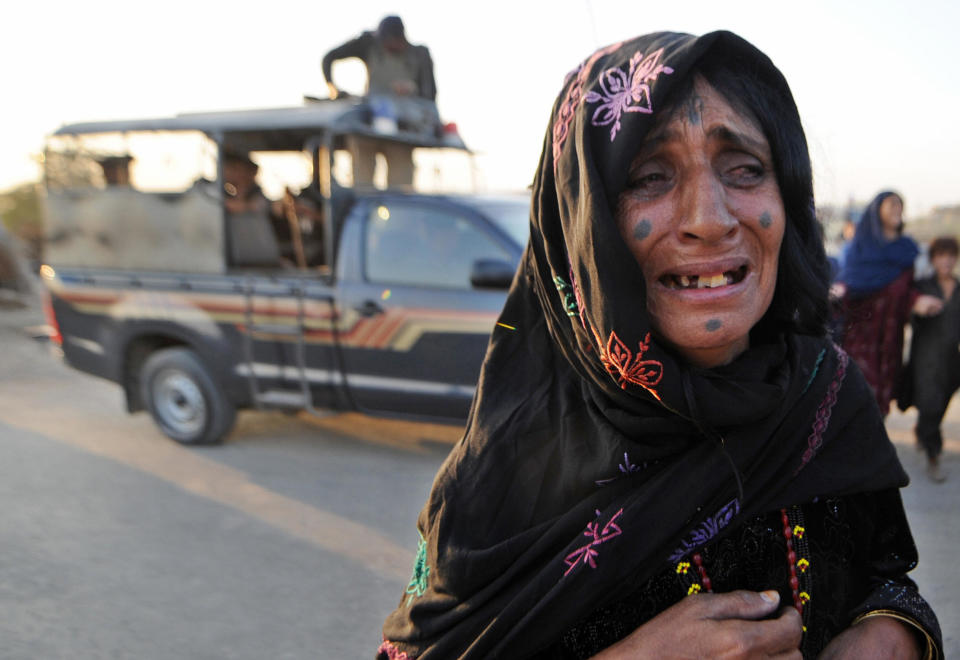 An Afghan refugee woman cries after troops arrest her relative during a search operation in the Afghan refugee camp in Karachi on December 2, 2008.&nbsp;