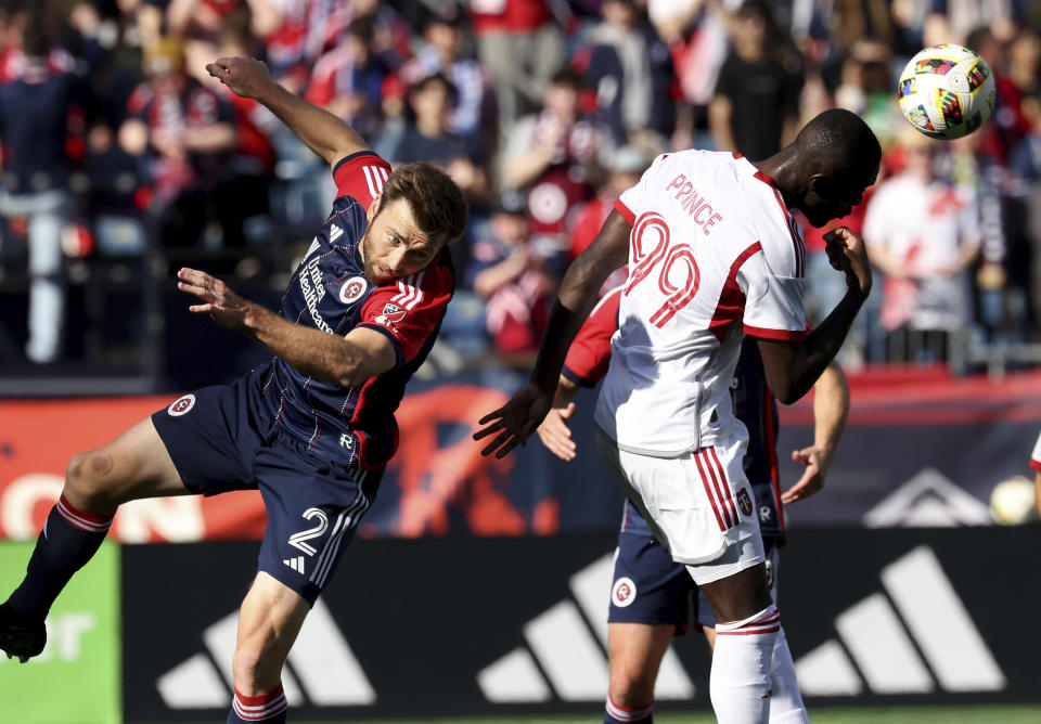 New England Revolution defender Dave Romney (2) and Toronto FC forward Adama Diomande (99) head the ball in the first half of an MLS soccer match Sunday, March 3, 2024, in Foxborough, Mass. (AP Photo/Mark Stockwell)