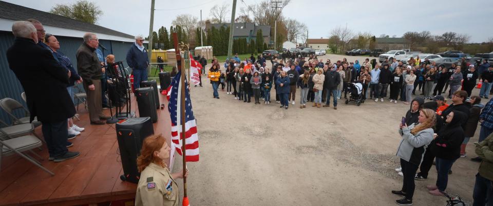 A group gathers during a candlelight vigil for Alanah and Zayn Phillips and other victims Friday at the Swan Boat Club.