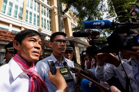 Uon Chhin and Yeang Sothearin, former journalists from the U.S.-funded Radio Free Asia (RFA), who have been charged with espionage, speak to the media in front of the Municipal Court of Phnom Penh after receiving their verdict, in Phnom Penh