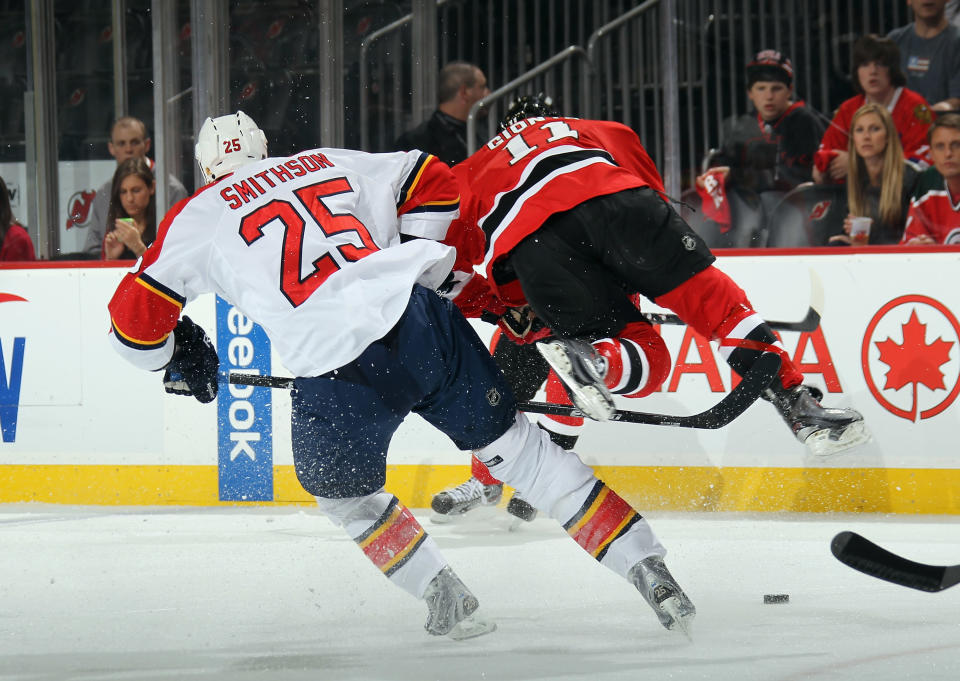 NEWARK, NJ - APRIL 19: Jerred Smithson #25 of the Florida Panthers upends Stephen Gionta #11 of the New Jersey Devils in Game Four of the Eastern Conference Quarterfinals during the 2012 NHL Stanley Cup Playoffs at Prudential Center on April 19, 2012 in Newark, New Jersey. (Photo by Bruce Bennett/Getty Images)