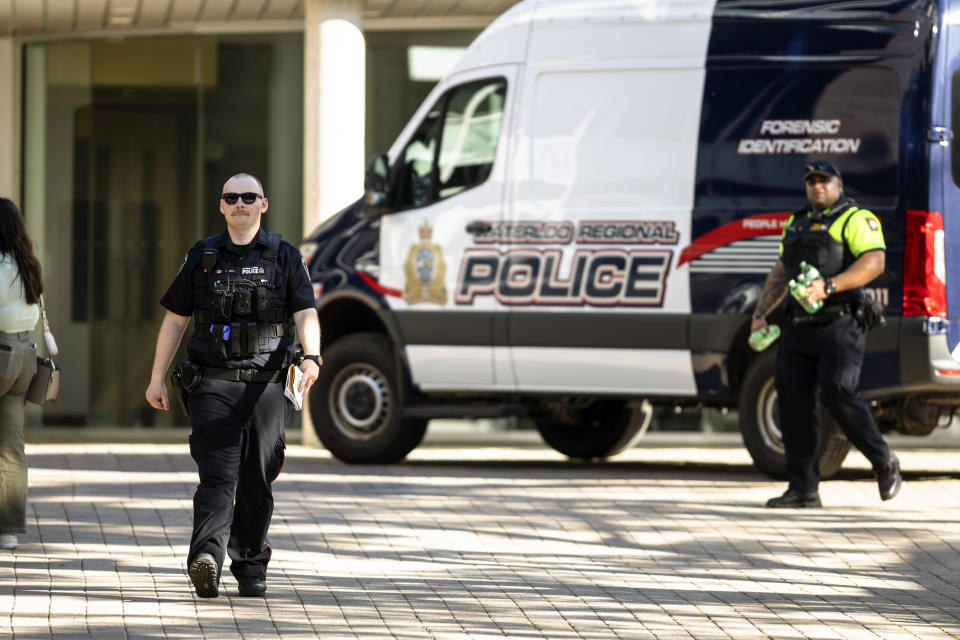 Members of the Waterloo Regional Police investigate a stabbing at the University of Waterloo, in Waterloo, Ontario, Wednesday, June 28, 2023. Police said three victims were stabbed inside the university's Hagey Hall, and a person was taken into custody. (Nick Iwanyshyn/The Canadian Press via AP)