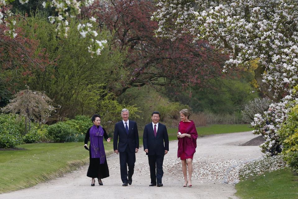 FILE - In this Sunday, March 30, 2014 file photo, from right, Belgium's Queen Mathilde, China's President Xi Jinping, Belgium's King Philippe and Chinese First Lady Peng Liyuan walk in the Royal Gardens of Laeken, Belgium. In a pandemic time rife with restrictions, demands to respect social distancing have become quasi impossible to respect in public parks. One family in town though, has a lush garden all its own and ever more voices are being raised that the Royal Family of King Philippe should loosen up and open up at least part of their Park of Laeken to the public. (AP Photo/Yves Herman, Pool, File)